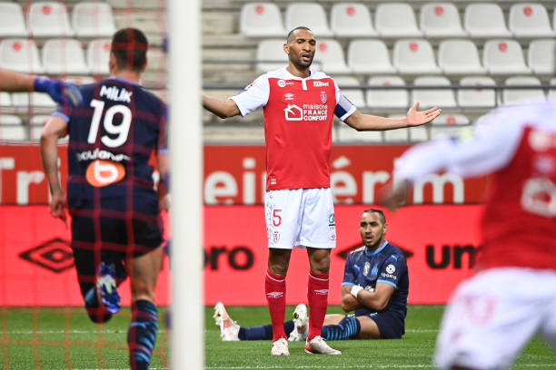 Arkadiusz MILIK of Marseille celebrates a goal with Dimitri PAYET of Marseille as Yunis ABDELHAMID of Reims looks dejected during the Ligue 1 match between Stade Reims and Olympique Marseille at Stade Auguste Delaune on April 23, 2021 in Reims, France. (Photo by Anthony Dibon/Icon Sport via Getty Images)