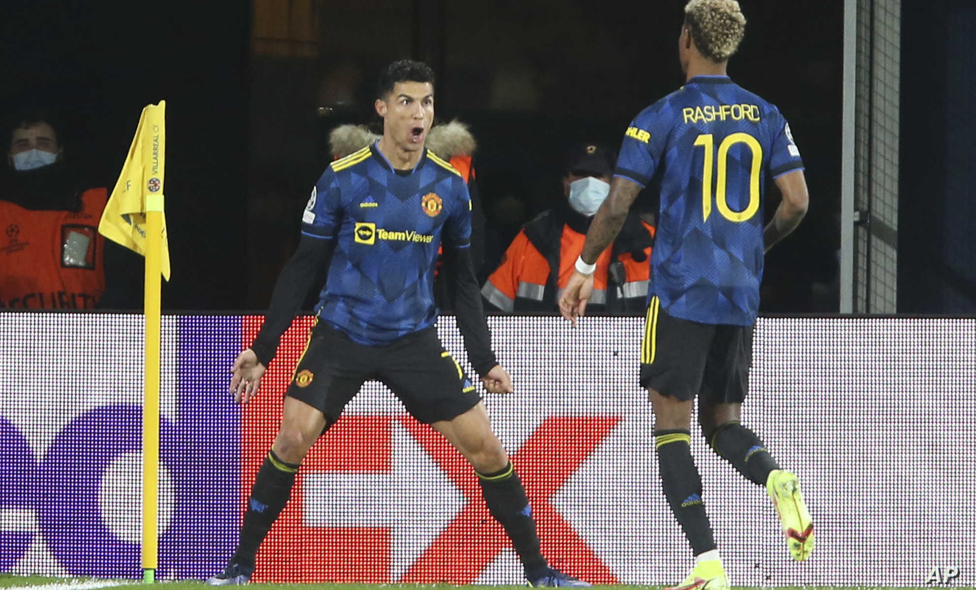 Manchester United's Cristiano Ronaldo, left, celebrates with Marcus Rashford after scoring the opening goal during a Group F Champions League soccer match between Villarreal and Manchester United at the Ceramica stadium in Villarreal, Spain, Tuesday, Nov. 23, 2021. (AP Photo/Alberto Saiz)